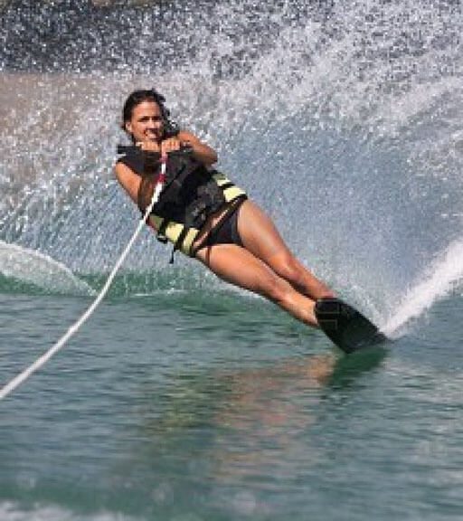 Woman wearing a life jacket vest Skiing at the Sea.
