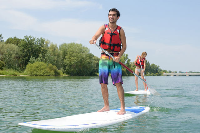 SPP Two people paddle boarding and wearing life vests